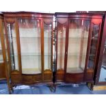 Pair of Edwardian inlaid mahogany bow front display cabinets, the bow front glazed door flanked by