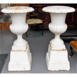 Pair of cast iron white painted garden pedestal urns upon square tapered stands, height 43in,