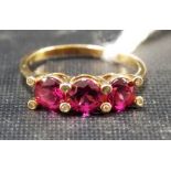 Modern yellow metal pink stone and diamond chip set ring, weight 2g approx.