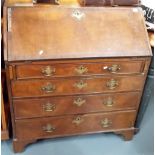 George III mahogany veneered and crossbanded bureau, the fall front with pigeonholes and an