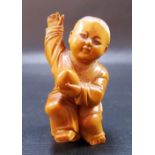 Chinese carved boxwood figure of a boy Buddhist monk holding a peach, height 2.75in.