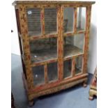 19th Century Burmese red and gilt painted display cabinet, the hinged doors with foliate carved