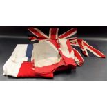 Five vintage printed Union Jack flags together with one other flag.