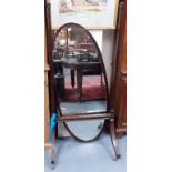 Edwardian mahogany cheval mirror, the oval bevel edged plate upon square section tapered supports