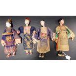 Four 19th/20th Century Chinese composition dolls wearing Court silk embroidered robes, height of