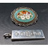 Italian white metal oval micro mosaic brooch, foliate decorated; together with a modern silver ingot