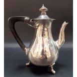 George V Art Nouveau style silver coffee pot, the ebony handle with stylised floral scroll mount