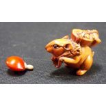 Small Japanese Boxwood Netsuke in the form of a mouse carrying a basket together with a little