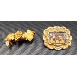 A Victorian yellow metal scroll embossed brooch with glass panel inset; together with a yellow metal