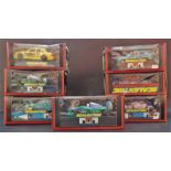 Seven modern Scalextric racing cars within original boxes.