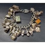 Silver charm bracelet with a quantity of various charms, weight 4oz approx.