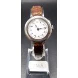 Silver lug wristwatch, the white enamel dial with Arabic numerals.