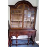 18th Century walnut feather band inlaid display bookcase on stand, the arched top over a pair of