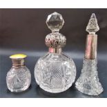 Three silver mounted cut glass scent bottles, one with guilloche yellow enamel screw lid, London