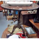 George III mahogany tilt top tripod table with baluster support, diameter 27in.
