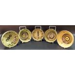 Set of five Sidney Tustin Winchcombe Pottery slipware bowls, impressed pottery and personal seals
