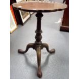 George III mahogany tripod table, the top with piecrust shaped edge over a baluster turned