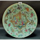 Chinese famille rose carved celadon dish decorated with a central reserve of figures within an