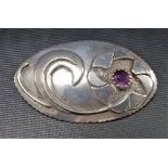 White metal mid-Century oval stylised flower brooch inset with an amethyst, length 6.25cm approx,