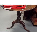 George III oak tripod table upon baluster turned supports and three outswept feet, diameter 34in.