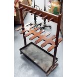 Edwardian mahogany umbrella stand with twelve sections over a drip tray and with brass carrying