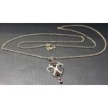 Edwardian Art Nouveau style silver pendant set with three cut amethysts, on a silver curb link