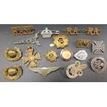 Collection of military badges including a silver Services Rendered badge, a white metal German