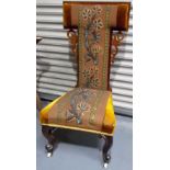 19th Century rosewood upholstered prie dieu chair upon cabriole forelegs with ceramic castors.