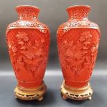 Pair of Chinese Cinnabar lacquer balluster vases and stands, both with reserves of rocks issuing