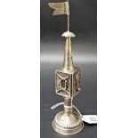 A white metal filigree incense burner with flag surmount.