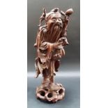 Oriental root carved figure of a sage holding a fruiting peach branch, glass inset eyes, height 12.
