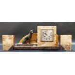 Art Deco French two-train garniture, the square clock and dial flanked by a spelter dog