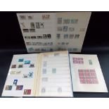 Stamp album of British Queen Elizabeth II stamps, some still in blocks; together with a sheet of