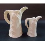 Graduated pair of Royal Worcester leaf moulded cream jugs, the largest height 4.75in