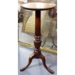 George III style torchiere with turned and fluted baluster support & raised on three outswept
