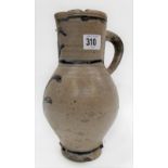 A 17th/18th Century German Westerwald stoneware jug, the grey salt glaze ovoid body with two incised