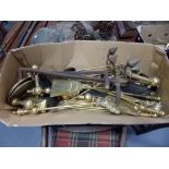 Box of Victorian brass fire implements together with a pair of wrought iron fire dogs