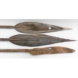 Three tribal paddles with leaf shaped blades, length of tallest 66.5in (all af)