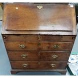 18th Century oak bureau, the fall front enclosing five pigeon holes and an arrangement of ten