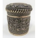 Indian white metal embossed cylindrical lidded pot, embossed and engraved with buildings amongst