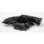 Victorian jet brooch carved as a hand with a floral garland.