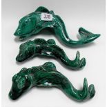 Three green glazed majolica models of coiled fish
