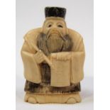Japanese Meiji period carved ivory Netsuke carved in the form of an elderly calligrapher holding