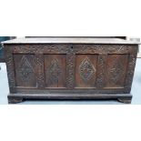 18th Century oak coffer, the four panel front with four foliate carved lozenge flanked with