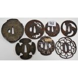 Seven various Japanese steel Tsuba, one with precious metal decoration