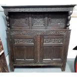 Charles II Oak carved court cupboard, the superstructure with carved frieze over a pair of