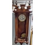 Vienna clock with two train movement and within walnut case, height 50in.