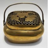 Chinese brass hand warmer with swing handle and pierced lid, height including handle 4in