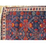 Good 20th Century Seichour wool rug decorated with geometric motifs and borders upon a blue