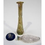 Ancient green iridescent glass vial, length 3in; together with a glass white opaque twisted